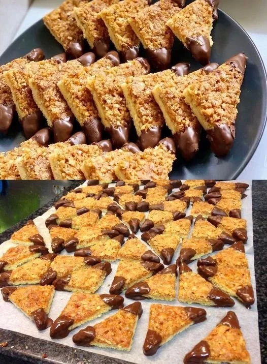 Biscotti Nussecken decorati con noci e glassa, perfetti per ogni occasione.